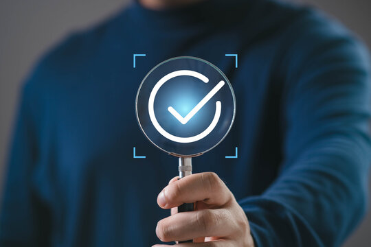 Magnifying glass highlighting a check mark icon, representing verification, approval, quality control, successful validation, compliance process, and confirmation of completed tasks.