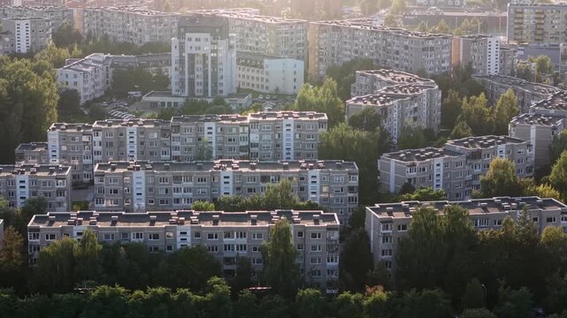 Aerial view of repetitive apartment buildings in Pa&scaron;ilaičiai residential district at sunset.