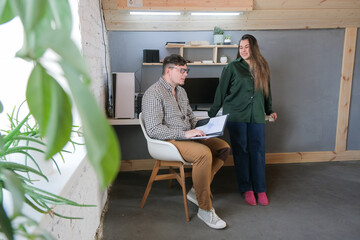 man and woman working in small office