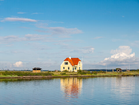 Albuehus on Albuen, seen from the lagoon on the sheltered side of Nakskov Fjord on Lolland in Denmark