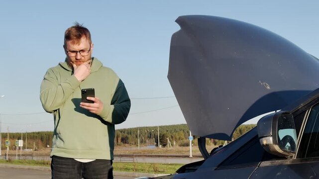 Calling a tow truck. A passenger car. A man using a smartphone. Slow motion video. High quality 4k footage