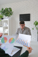 man and woman working in small office