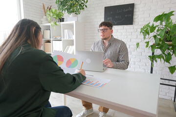 man and woman working in small office