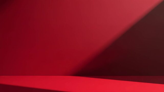 Shifting off-frame light source casting diagonal shadow across red platform, altering backdrop