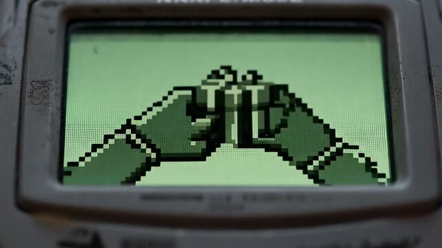 Playing pixel animation showing hands transferring wrapped gift on handheld screen with bezel wear