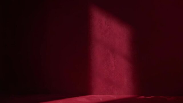 Moving red patch in dim room pulsing fading returning on right-wall casting floor band, copy space