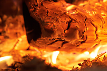 Homemade warm orange campfire with pieces of firewood. Burning firewood in the stove, coal, hot coals,