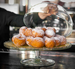 Many donuts on a glass tray