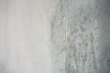 weathered textured concrete wall with white paint splashes and vertical streaks