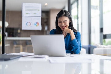 Fototapeta premium Beautiful&nbsp;Business Woman working by using laptop computer Hands typing on keyboard. Professional investor working new start up project. business planning in office. Technology business