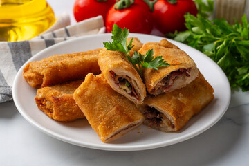 Turkish Pacanga Boregi with pastirma (pastrami) and cheddar (melted) cheese. - Pastirmali Borek