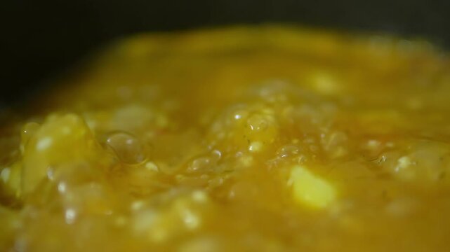 Chicken soup cooking in a saucepan. Slow motion. 