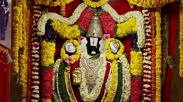 A panoramic video of deity god venkateswara decorated with flowers and ornaments in temple