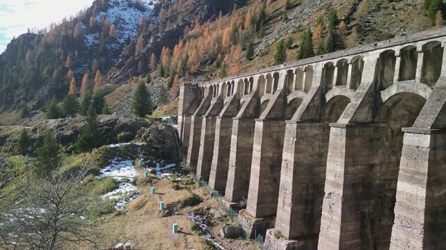 The Gleno Dam (Italy) is a historic ruin that collapsed in 1923, causing a tragic flood. Today, its impressive remains serve as a hiking destination and a powerful memorial to the disaster.