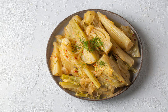 Organic Baked Fennel Bulbs with Salt and Pepper. Fennel dish with olive oil.