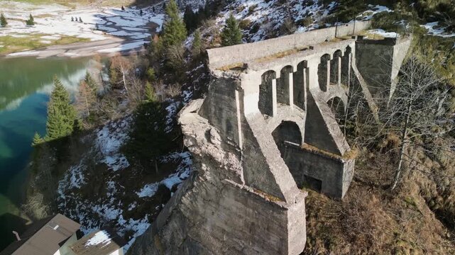 The Gleno Dam (Italy) is a historic ruin that collapsed in 1923, causing a tragic flood. Today, its impressive remains serve as a hiking destination and a powerful memorial to the disaster.