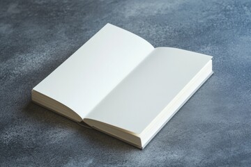 Fototapeta premium Blank book placed on a gray surface for writing or drawing ideas and notes in a simple setting