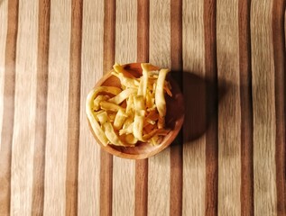 Close up of yellow food snack in wooden bowl