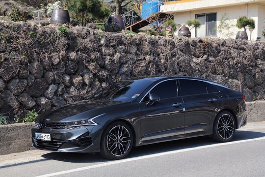 HWAGAE-MYEON, SOUTH KOREA - APRIL 2, 2023: Kia Optima car also known as Kia K5, Korean mid-size sedan car parked along rural road.