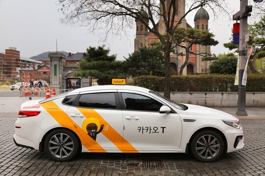 JEONJU, SOUTH KOREA - APRIL 4, 2023: Kakao T taxi drives in Jeonju. Kakao T (formerly KakaoTaxi) is a popular Korean transportation service mobile app.