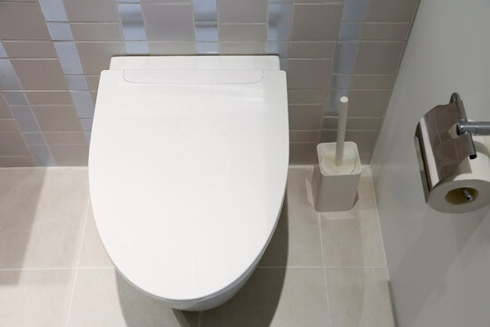 A white smart toilet is in the bathroom.