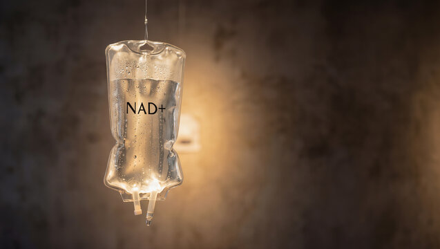 NAD infusion bag hung against a glowing warm background symbolizing modern biohacking and longevity trends for health and wellness enhancement. Image made using Generative AI.