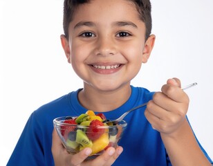A cheerful boy enjoys a colorful bowl of fresh fruit salad.