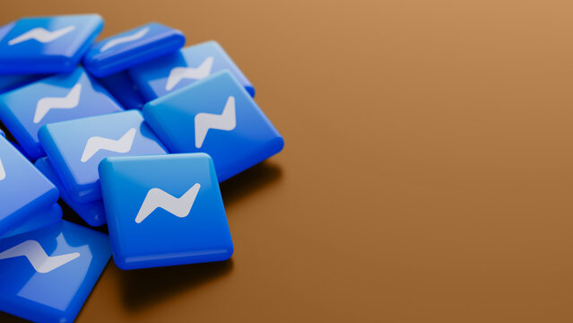 Berlin, Germany - January 29, 2026: Close-up of the Facebook Messenger logo in a pile on bronze background with copy space as web banner header