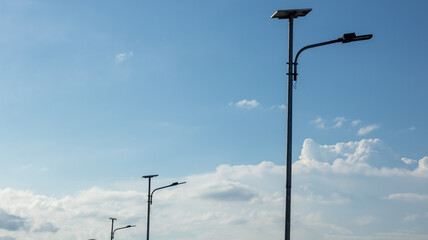 Solar Powered Street Lights Against Blue Sky