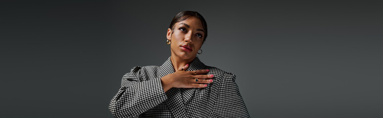 Fashion-forward young woman posing elegantly in a stylish studio setting