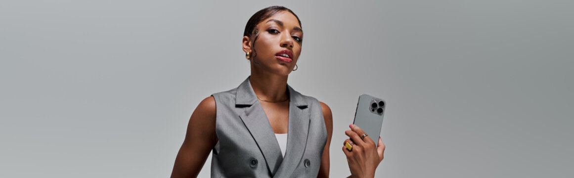 Stunning young woman exudes confidence in stylish smart casual attire in modern studio