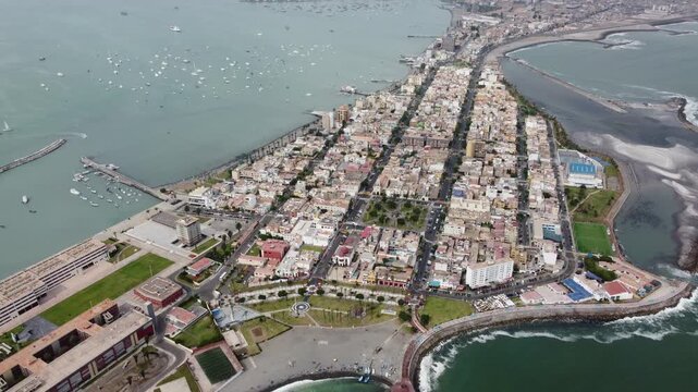 aerial view callao peninsula coastal city, dense grid of low rise buildings, palm lined promenade
