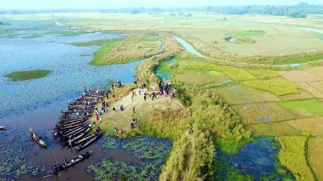 Drone top view of a row of boats on the Dibir Lake a beautiful and famous tourist spot located at the foot of the Meghalaya hills in Jaintapur, Sylhet, near the Bangladesh-India border.