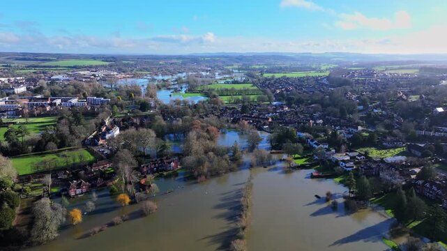 Tracking aerial shot over a flooded River Avon in Salisbury, UK following Storm Chandra.