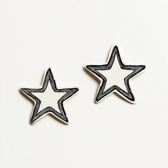 Two white stars with a rough, scribbled black outline against a pale background