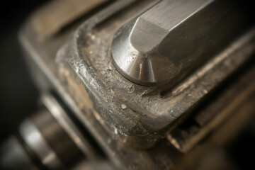 Gritty, textured surface of an aged metal industrial part, showing wear and the raw material's character.