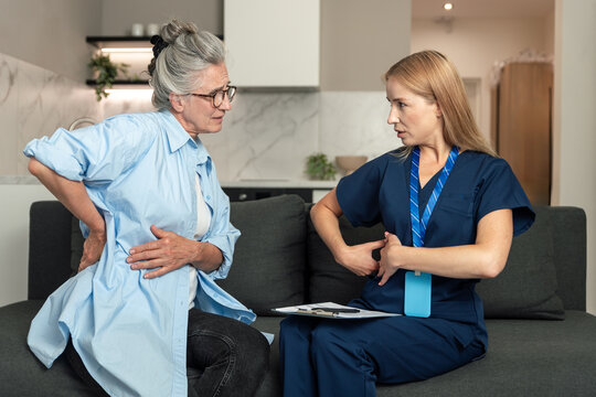 Healthcare professional visits elderly woman at home for medical consultation