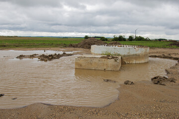 old wind turbine foundation surrounded by water