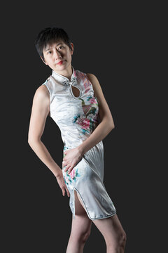 Chinese woman in white traditional dress leans backwards