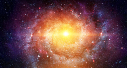 Bright spiral galaxy with a glowing core surrounded by stars, dust, and cosmic clouds in deep space. Abstract cosmic collage background. Elements of this image furnished by NASA.