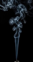 Smooth blue incense smoke swirls in abstract wave patterns and light curves against a black background to create a motion effect of transparent flowing air and artistic design