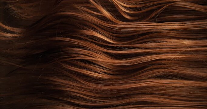 Ultra slow motion shot of dark brown hair flowing in smooth, elegant waves, forming natural curves and motion. Captured at 1000 fps, revealing fine texture, shine, and fluid cinematic movement.