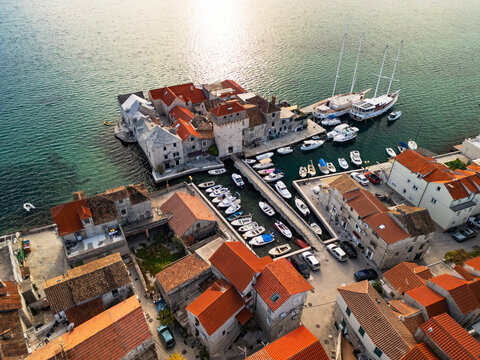 Epic aerial view of the medieval Ka&scaron;tilac fortress in Ka&scaron;tel Gomilica, historic stone castle built in the Adriatic sea, famous film location in Croatia, 4K