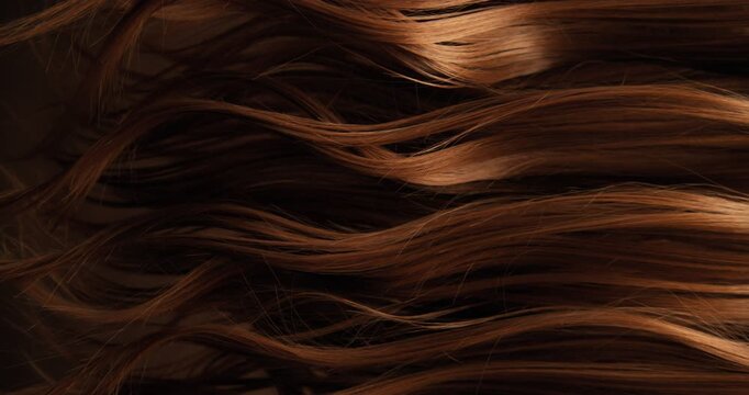 Ultra slow motion shot of dark brown hair flowing in smooth, elegant waves, forming natural curves and motion. Captured at 1000 fps, revealing fine texture, shine, and fluid cinematic movement.