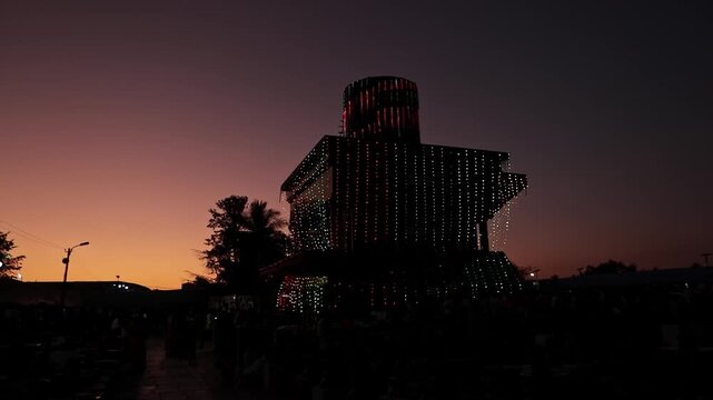 An epic zoomed view of the tallest Shivalinga during dusk decorated with lights at Kolar