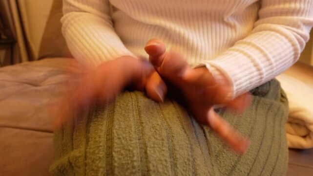 Anxious woman's hands fidgeting restlessly
