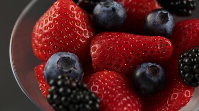 Strawberries Blackberries And Blueberries In A Cup Rotating