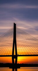 Obraz premium Silhouette of a cable-stayed bridge at sunset.