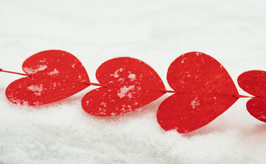 Fototapeta premium red hearts on the snow=