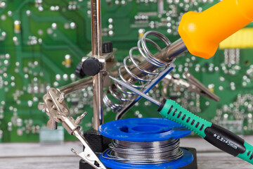 electrical board with a soldering iron and screwdrivers